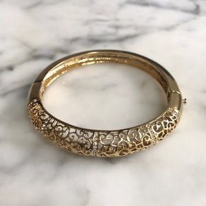Gold tone bracelet with decorative stones